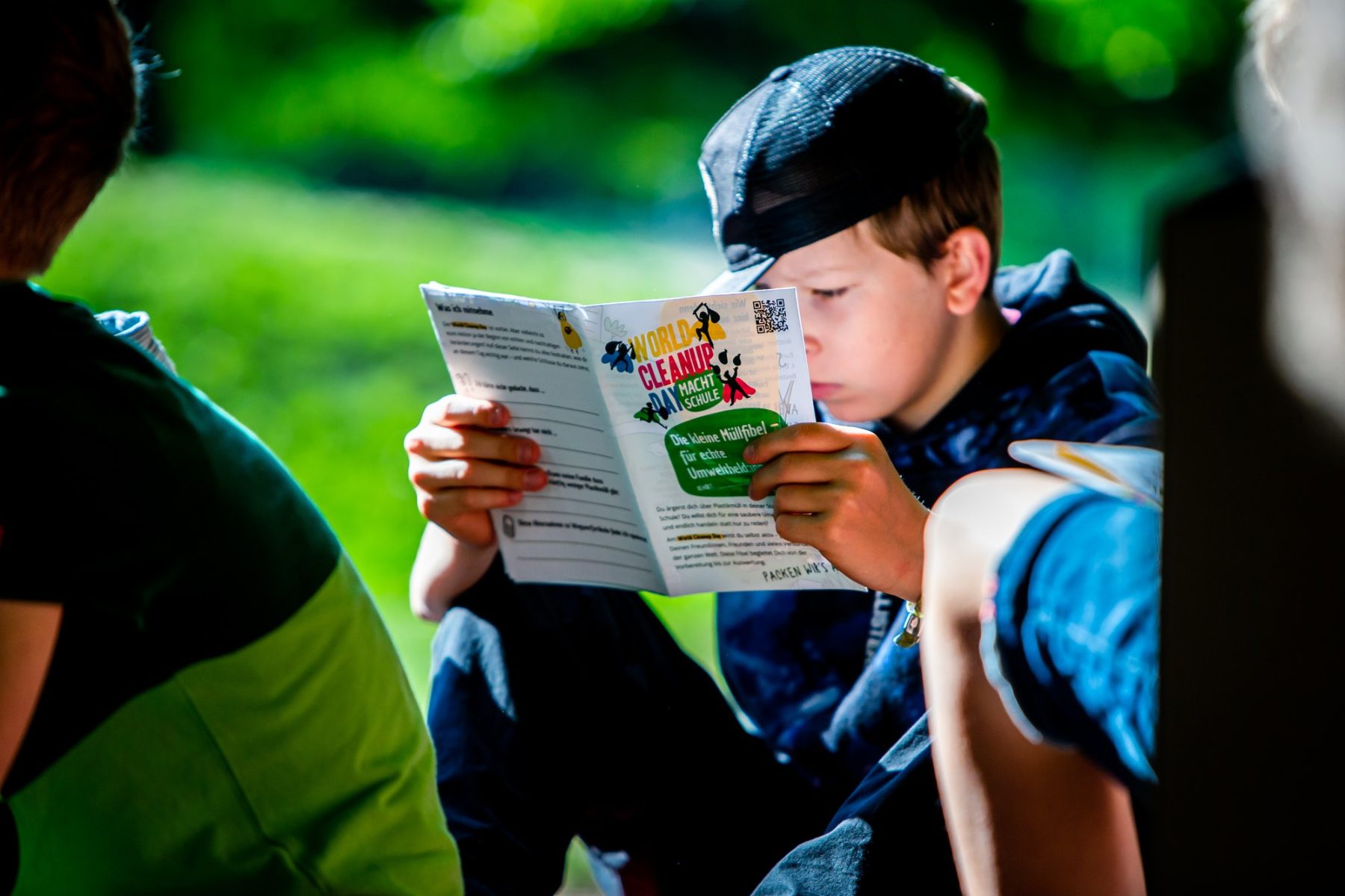 Pupil reading the World Cleanup Day school booklet